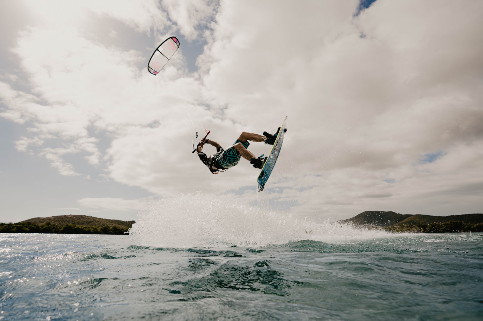 Kiteboarder jumping above the water